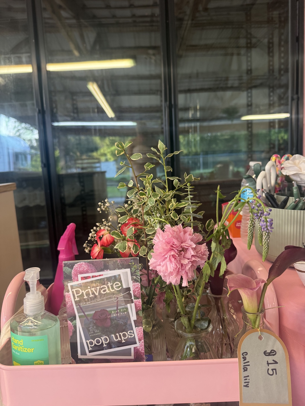 Pink bloom bar cart with flowers and private pop-up signage